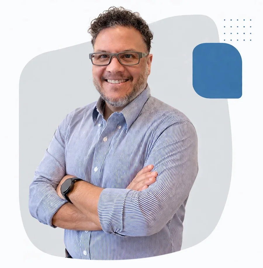 Victor Alvarez standing with his arm crossed, smiling and looking at the camera