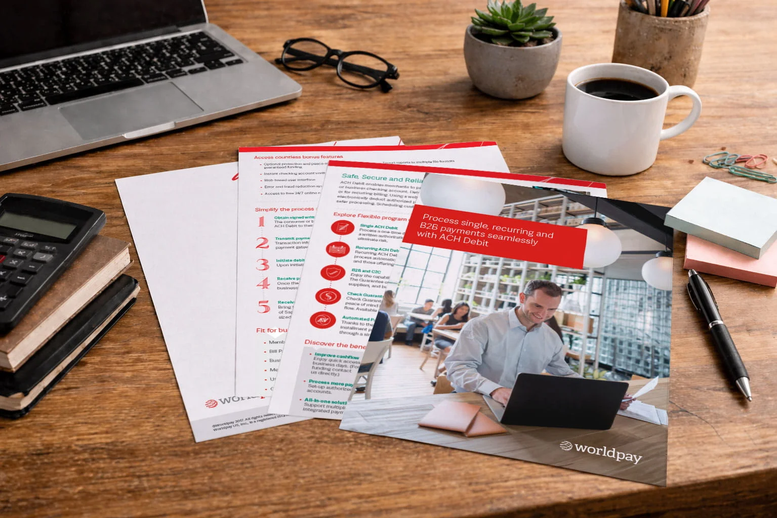 ACH payment processing brochure with professional working on laptop.